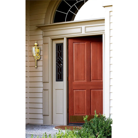 One Light Exterior Wall Lantern In Polished Brass Finish With Clear Beveled Glass For Crisp Outdoor Porch Lighting, 18.5 In High By 5.75 In Wide, Extends 6 In, 11.5 In Center Of Outlet Box Height, Back Plate 4.5 In installed beside a red door