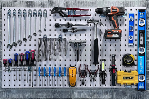 LockHook Steel Pegboard Hook Set 63 Piece Garage Organization Kit showing tools neatly arranged on a pegboard with wrenches and drill.