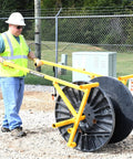 Worker using Beefed-Up Heavy Duty Portable Reel Buck With Adjustable Steel Cable Reel Stand, 1000 Lb Capacity on job site