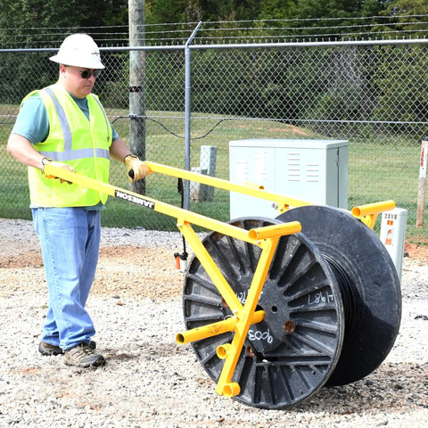 Worker using Beefed-Up Heavy Duty Portable Reel Buck With Adjustable Steel Cable Reel Stand, 1000 Lb Capacity on job site