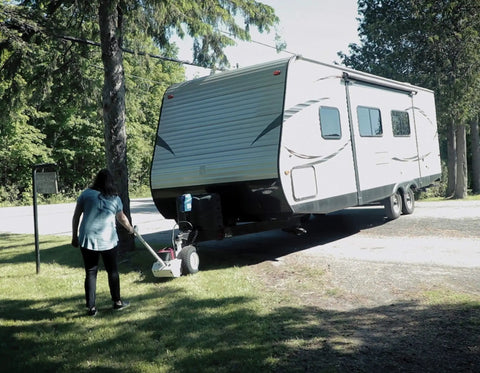 Force 5K Electric Trailer Dolly for RV, Boat and Cargo Trailers moving a travel trailer on grass with ease.