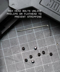 Gun Plug Screw Set For Rifle And Shotgun Receivers That Snaps Into Factory Optics Ports, hex head bolts on grid surface.