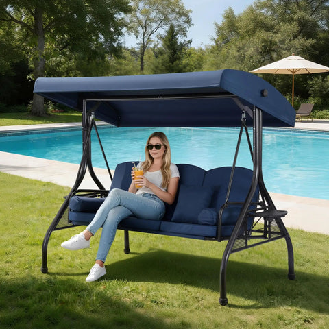 Woman sitting on Three Seat Outdoor Porch Swing With Adjustable Canopy And 2 In 1 Convertible Bed For Backyard Blue With Cup Holder And Pillow
