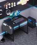 Space Saving Computer Desk For Small Spaces 31 Inch Home Office Table For Gaming And Study With Large Surface And Sturdy Steel Frame Includes Storage Bag For Bedroom Black in modern gaming setup with monitor and accessories.