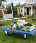 Heavy Duty Foldable Push Cart Dolly with tools and soil bags on a yard, showcasing smooth rolling swivel wheels for easy transport.