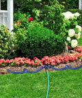 360 Degree Tree Watering Ring Kit For New Trees And Shrubs With Y Hose Splitter installed in garden with colorful flowers