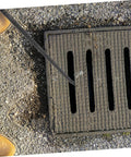Heavy Duty Multi Function Manhole Cover Lifter With Thick T Shaped Handle For Roller Shutters And Sliding Doors Top Notch No Sweat Pulling Tool Set Pro Grade lifting a manhole cover on a concrete surface.