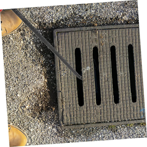 Heavy Duty Multi Function Manhole Cover Lifter With Thick T Shaped Handle For Roller Shutters And Sliding Doors Top Notch No Sweat Pulling Tool Set Pro Grade lifting a manhole cover on a concrete surface.