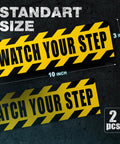 Caution Floor Decals 10x3 Inches Yellow Reflective Stickers For Steps Waterproof Self Adhesive Signage Watch Your Step With Bold Black Lettering And Diagonal Stripes Two Pack shown in standard size