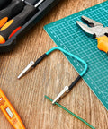 4 Pack No Hands Wire Holders For Soldering Green Helping Hands Clip with tools on a workbench