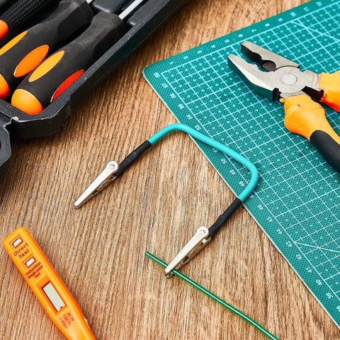 4 Pack No Hands Wire Holders For Soldering Green Helping Hands Clip with tools on a workbench