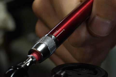 Close-up of T Ratchet Torque Kit with Titanium Torsion Beam adjusting a screw, showing precision tool in use.