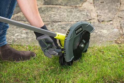 18V ONE Plus Cordless Edger Bare Tool with 22cm Serrated Edging Blade being used for lawn edge trimming
