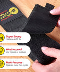 Close-up of hands holding Wrap-It Storage Straps 17-Inch 2-Pack Heavy-Duty Hook And Loop Cord Carrier with labeling details.