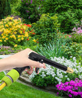 Person using Garden Quick Connect Water Connector Set Half Inch Hose Pipe Repair And Irrigation 4 Pack Durable ABS in garden
