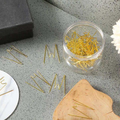 Super Slick Gold Cubicle Hooks For Fabric Partition Walls Tough Stainless Steel Wire Clips in jar on gray surface