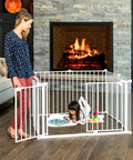 Super Wide Baby Gate And Play Yard For Large Openings Expands To 192 Inches Wide Eight Panel Gate With Walk Through Doors Hardware Mounted For Babies Toddlers And Pets in living room setup with child and adult
