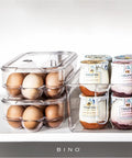 Clear Fridge Egg Container, 21 Egg Capacity, No Fuss Sturdy Plastic Egg Tray With Lid, Freshness Preserver next to yogurt jars