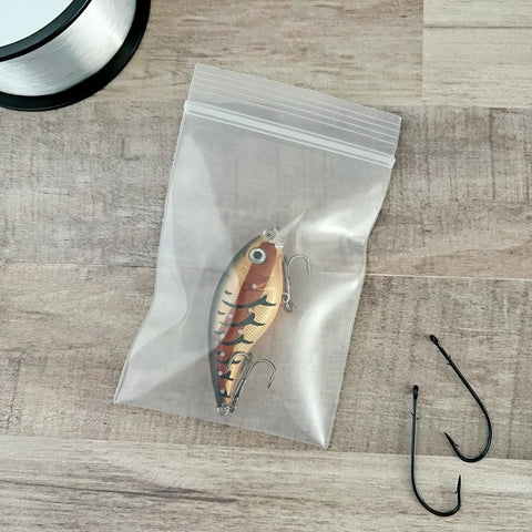 3x4 Inch Clear Zipper Reclosable Bags, 6 Mil Heavy Duty Storage Bags Pack Of 100, FDA Food Safe Transparent LDPE For Organization And Food Prep For Grab And Go Kitchen Or Office Storage holding a fishing lure