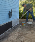 Man applying 1-gallon Liquid Rubber Sealant Coating for waterproof, flexible protection on house foundation with brush roll tool.
