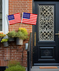 Entrance decorated with 12 Pcs 8x12 Inch American Flags On Wooden Sticks 17.5 Inch Tall Outdoor Handheld Flags by the door