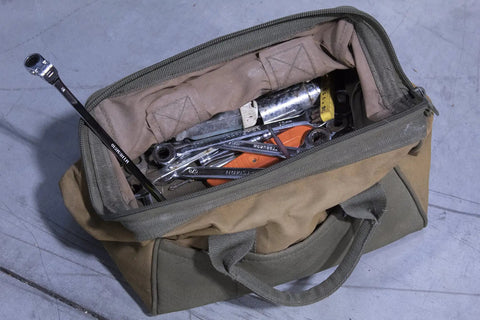 Open tool bag on concrete floor with various wrenches, including 8x10mm Double Box Universal Spline Reversible Ratcheting Wrench MTNRM810