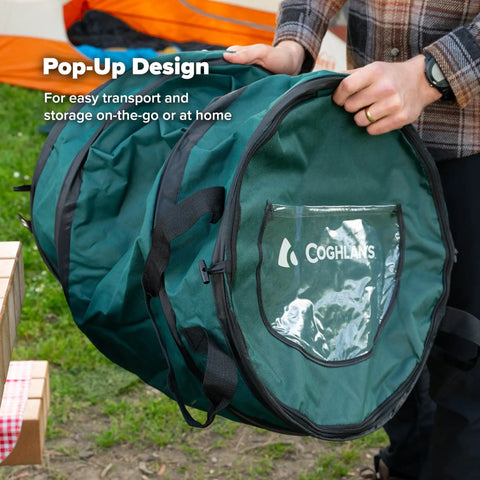 Man holding Deluxe Pop Up Trash Can With Zippered Lid Collapsible 29.5 Gallon Bin at outdoor event
