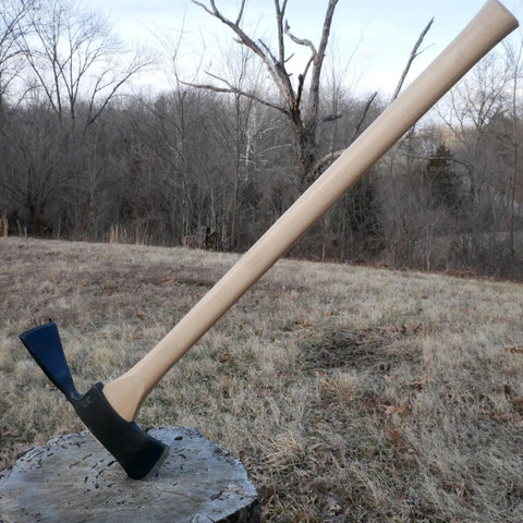 Pulaski Style Wildfire Axe With 3.75 Lb Forged Steel Head And 36 Inch Hickory Handle displayed on a tree stump in forest setting.