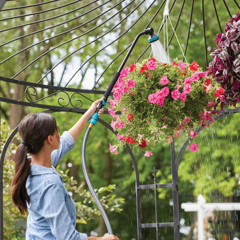 Person using Heavy Duty Swivel Connect Watering Wand Hose Sprayer With Five Spray Patterns For Garden Hose on hanging flowers