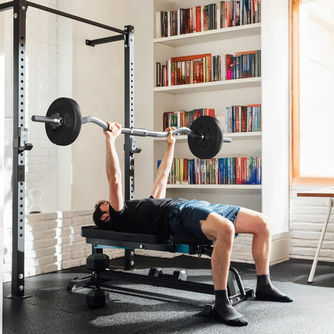 Man using Olympic Curl Bar Weight Set with Six Plates and Bar Clamps for Lifts 55Lb Home Gym in room with bookshelf and window.