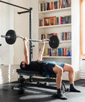 Man using Adjustable Olympic Curl Barbell Set With Four 5.5 Lb Plates And Two 11 Lb Plates, Curl Bar, Star Lock Collars, in home gym