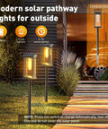 Rectangle Solar Pathway Lights Outdoor 6 Pack Super Bright Auto On Off No Fuss Landscape LED Lights For Walkway Garden And Driveway 10 Hours Run Time Weatherproof Solar Landscape Lighting illuminating a modern pathway at night.