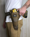 Side view of person wearing Aims Large Drill Holster for Left Handed Pros Handcrafted in the USA, fits a power drill, made from 1000D Cordura Nylon.