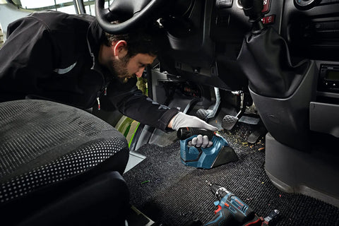 Man using 12V Max Hand Vacuum Bare Tool For Quick Jobsite Cleanup With Ultra Lightweight Design in vehicle interior