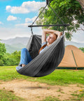 Hanging Hammock Chair Outdoor Swing For Camping And Travel, Collapsible Tree Pod Style Hammock With Side Pocket in use outdoors