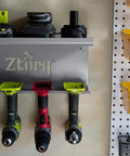 Cordless Drill Tool Organizer Wall Mount Charger and Storage Rack for Garage Organization Drill Holder Power Tool Shelf Battery Dock Pegboard Friendly Keeps Your Tools Neat and Ready installed on wall with drills and pegboard