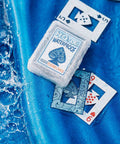 Waterproof Plastic Playing Cards Deck on blue surface with water splashes, ideal for outdoor fun beach pool camping travel games.