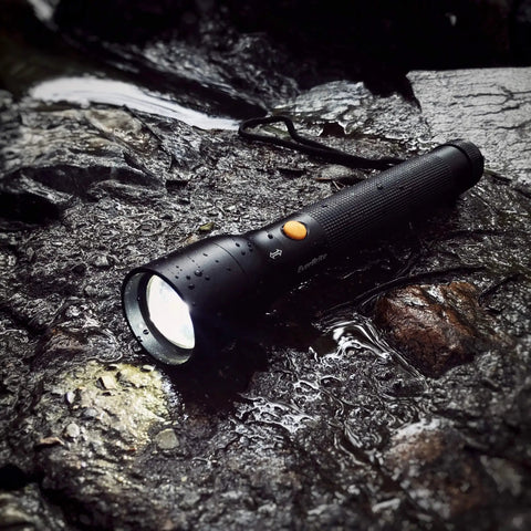Ultra Bright Tactical Flashlight With 900 Lumen Zoomable Beam And Adjustable Focus, 3 Light Modes High Low Strobe, on wet rocks