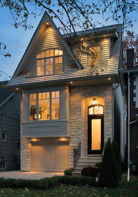 Top Shelf 6 Inch LED Recessed Downlights With Adjustable Color Temperature illuminating a modern home exterior at dusk.