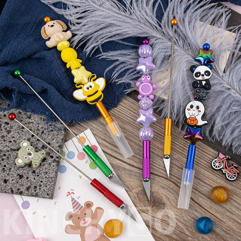 Colorful 12 Pack Beadable Letter Openers Set, Metal Beaded Envelope Openers With Plastic Protective Covers, shown on fabric