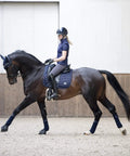 Rider on horse with Loire Classic Dressage Square Navy Large With Woven Satin Shine And Bamboo Breathable Comfort Ultra Soft Pad