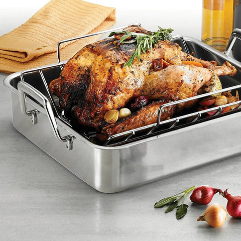Deep Stainless Steel Roasting Pan With Basting Grill And V Rack For Oven 16.5 Inch Turkey Roaster, loaded with a roasted turkey