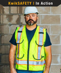 Person wearing High Visibility Safety Vest With Cushioned Collar And Reflective Trim Class 2 ANSI OSHA 9 Pockets for Tools and Tablets.