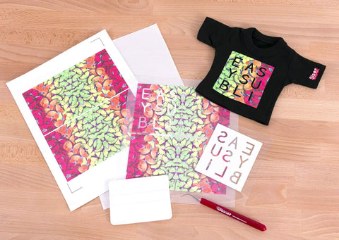 EasySubli Printable Sublimation Heat Transfer Vinyl Kit with vibrant designs, mask sheets, and sample tee on a wooden surface.