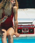 Dope Red Boombox With Bluetooth MP3 Converter From Radio To Cassette by poolside with woman in red swimsuit enjoying music