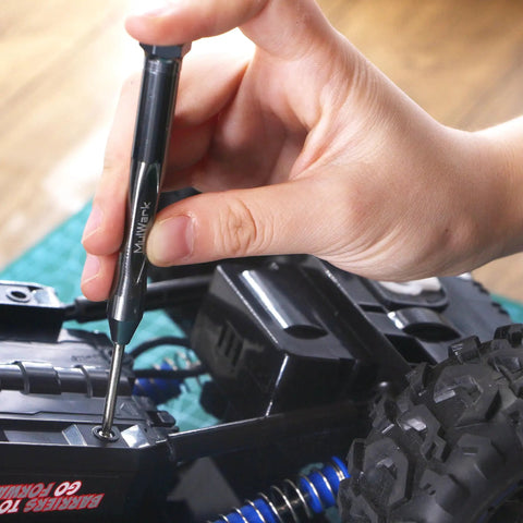 Using Tiny But Mighty Six Piece Magnetic Micro Precision Screwdriver for delicate electronics repair on toy car, hand close-up