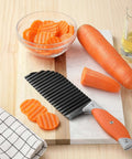 Crinkle Cut Knife For Veggies And Fries With Stainless Steel Wave Blade And Ergonomic Handle VITUER next to sliced carrots on board