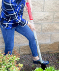 Person using DigMaster Nursery Shovel With ComfortGEL Grip Heavy Duty Steel Blade For Planting Transplanting And Landscaping Ergonomic Garden Spade Built For Pros And Weekend DIYers in garden