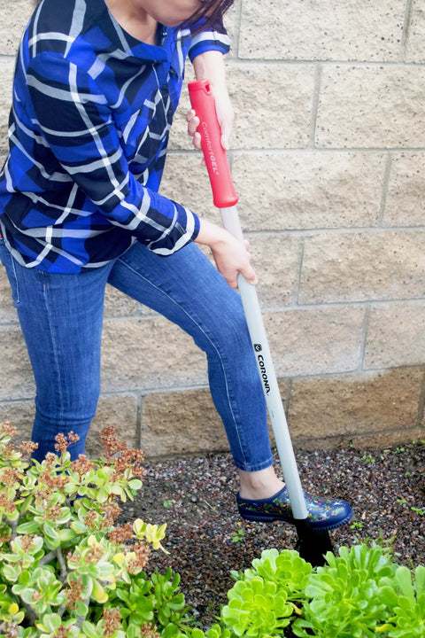 Person using DigMaster Nursery Shovel With ComfortGEL Grip Heavy Duty Steel Blade For Planting Transplanting And Landscaping Ergonomic Garden Spade Built For Pros And Weekend DIYers in garden