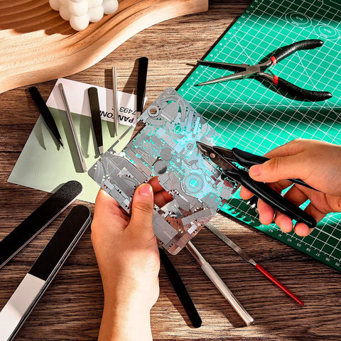 17 Piece Metal Puzzle Tool Set For DIY Model Kits Featuring Edge Bending Tools showing hands using clippers on metal sheet